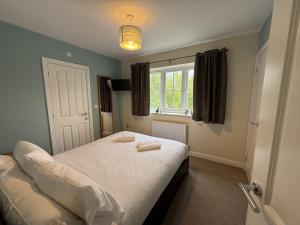 a bedroom with a bed with two towels on it at Anchors Away at The Bay Filey, sleeps 7, 2 dogs welcome for free too in Filey +20 photos