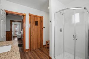 a bathroom with a glass shower and a toilet at Birch View- Balcony-Backyard-Parking-Sauna-Sleeps 20 in Blue Mountains +27 photos