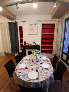 a dining room table with a table cloth on it at Le Thiers Studio in Auxonne