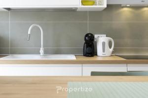 a kitchen counter with a sink and a faucet at Verde Appartamento Moderno in Monserrato