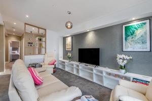 a living room with white furniture and a flat screen tv at 3 Bed in Tallington oc-s30309 in Yaxley