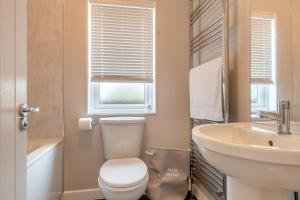 a bathroom with a toilet and a sink at 3 Bed in Tallington oc-s30309 in Yaxley +17 photos