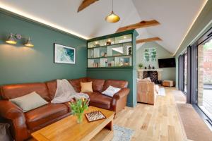 a living room with a leather couch and a table at 4 Bed in Broadstairs oc-w28331 in Broadstairs