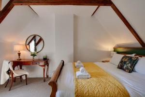 a bedroom with a bed and a desk with a mirror at 4 Bed in Broadstairs oc-w28331 in Broadstairs