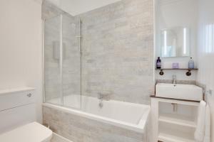 a white bathroom with a tub and a sink at 4 Bed in Broadstairs oc-w28331 in Broadstairs +40 photos
