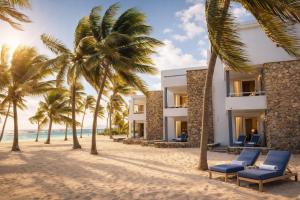 a resort on the beach with palm trees and chairs at Palms Resort and Beach in La Grande Princesse