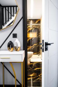 a bathroom with a black and gold wall at Bristol Boutique Stay in Bristol +67 photos