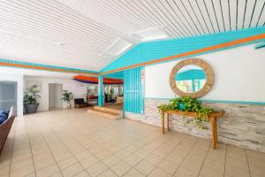 a lobby with a blue and orange ceiling at Palms Resort and Beach in La Grande Princesse +128 photos