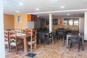 a restaurant with tables and chairs in a room at Pousada Porto Maresias in Cabo Frio