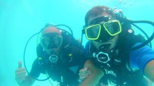 two people in diving gear posing for a picture at casa vacanza La Palma Rossa Taranto in Taranto