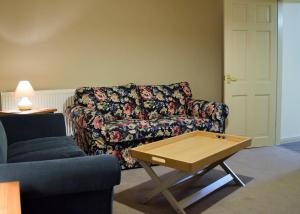 a living room with a couch and a coffee table at Sandhurst Farm Forge in Sittingbourne