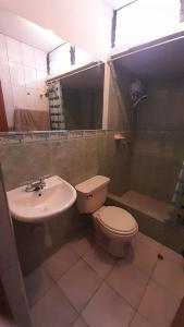 a bathroom with a toilet and a sink at Kenatural in Cajamarca