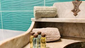 a bathroom with two bottles of oil on a table next to a tub at BellaVista in Saluggia