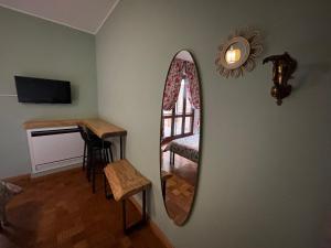 a mirror on a wall with a chair and a table at BellaVista in Saluggia +12 photos