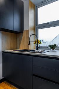 a black kitchen with a sink and a window at Bristol Boutique Stay in Bristol