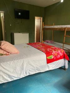 a bedroom with two bunk beds and a television at Quarto econômico central in Sete Lagoas