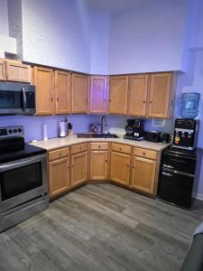 a kitchen with wooden cabinets and a black appliances at Alaynah's Place in Brunswick +8 photos