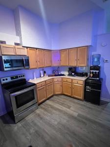 a kitchen with wooden cabinets and black appliances at Alaynah's Place in Brunswick