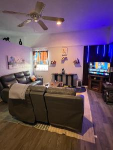 a living room with a couch and a flat screen tv at Alaynah's Place in Brunswick