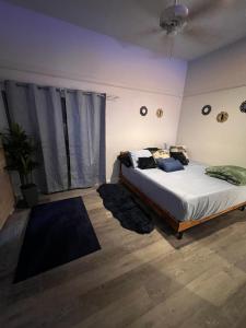 a bedroom with a bed and a large window at Alaynah's Place in Brunswick