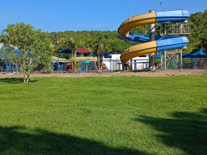 a playground with a slide in a park at Finca Ecoturística Canaguaros in Tauramena +47 photos