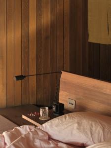 a bedroom with a bed and a wooden wall at Moke Valley Queenstown in Queenstown