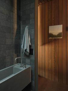 a bathroom with a sink and a bath tub at Moke Valley Queenstown in Queenstown