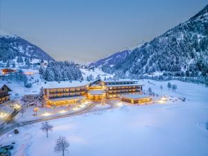 an aerial view of a resort in the snow at Defereggental Hotel & Resort in Sankt Veit in Defereggen