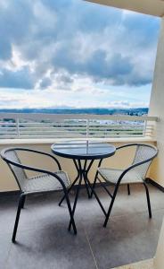 a table and two chairs on a balcony with a view at Valença Sky View in Valença +2 photos