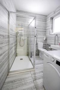 a bathroom with a shower and a toilet and a sink at The Oyster - F in Il-Furjana