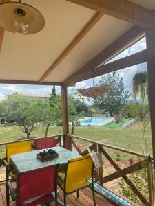 a patio with a table and chairs on a deck at Chalet Majoie in Les Mages