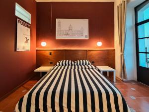 a bedroom with a large bed with two tables at Casa Serdán in Puebla