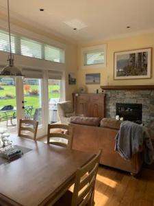 a living room with a couch and a fireplace at Qualicum Landing Beachside Home in Qualicum Beach