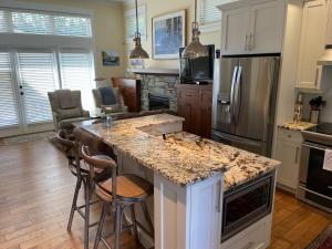 a kitchen with a large island with a counter top at Qualicum Landing Beachside Home in Qualicum Beach