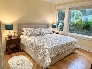 a bedroom with a bed and a window at Qualicum Landing Beachside Home in Qualicum Beach