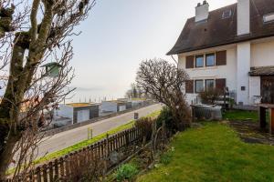 a house on the side of a road at Panoramic apartment with charming swiss interior in Wädenswil