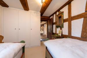 two beds in a room with wooden ceilings at Panoramic apartment with charming swiss interior in Wädenswil