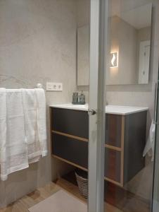 a bathroom with a sink and a mirror at Las Meanas Presbítero 6 in Avilés +27 photos