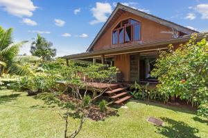 a house with a garden in front of it at Tropical 2BR Bungalow with Private Pool in Taravao