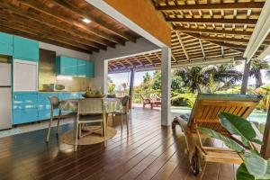 a kitchen and dining room with a table and chairs at Tropical 2BR Bungalow with Private Pool in Taravao