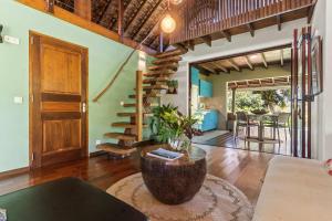 a living room with a wooden door and a table at Tropical 2BR Bungalow with Private Pool in Taravao +31 photos