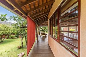 a hallway of a house with red walls and windows at Peaceful 2BR Garden Bungalow in Taravao