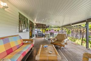 a living room with two couches and a coffee table at Peaceful 2BR Garden Bungalow in Taravao +16 photos