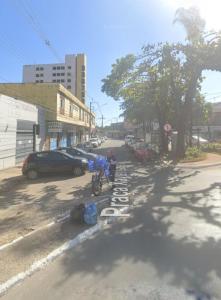 a boy on a bike on a city street at Hotel no centro in Sete Lagoas