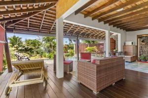an open patio with a table and chairs on a deck at Charming Tropical Retreat with Private Pool in Taravao