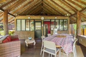 a conservatory with a table and chairs on a patio at Charming Tropical Retreat with Private Pool in Taravao +31 photos