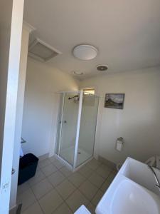 a bathroom with a shower and a sink at Ideal Melbourne Seaside Home in Mentone