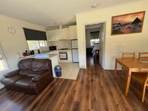 a kitchen and living room with a couch and a table at Ideal Melbourne Seaside Home in Mentone +12 photos