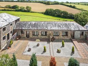 an aerial view of a stone house with a courtyard at Shire Cottage - Uk50029 in Liskeard