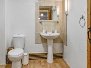 a bathroom with a toilet and a sink at Shire Cottage - Uk50029 in Liskeard